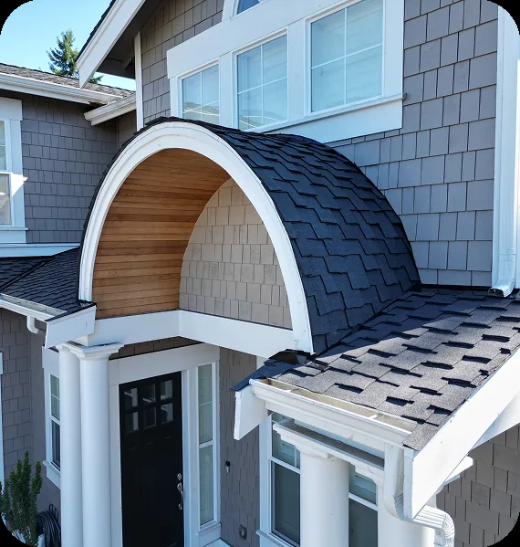 Shingles laid over a curved barrel-arch entry dormer